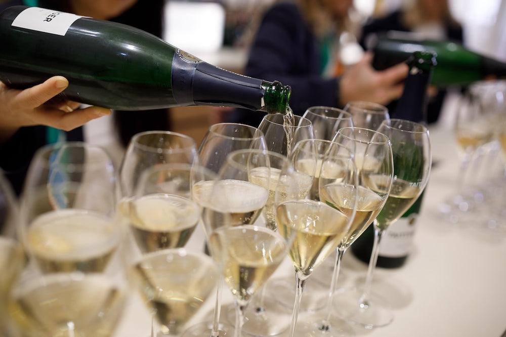 Champagne poured into a row of flutes